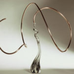 Abstract glass sculpture with elegant swirling design.