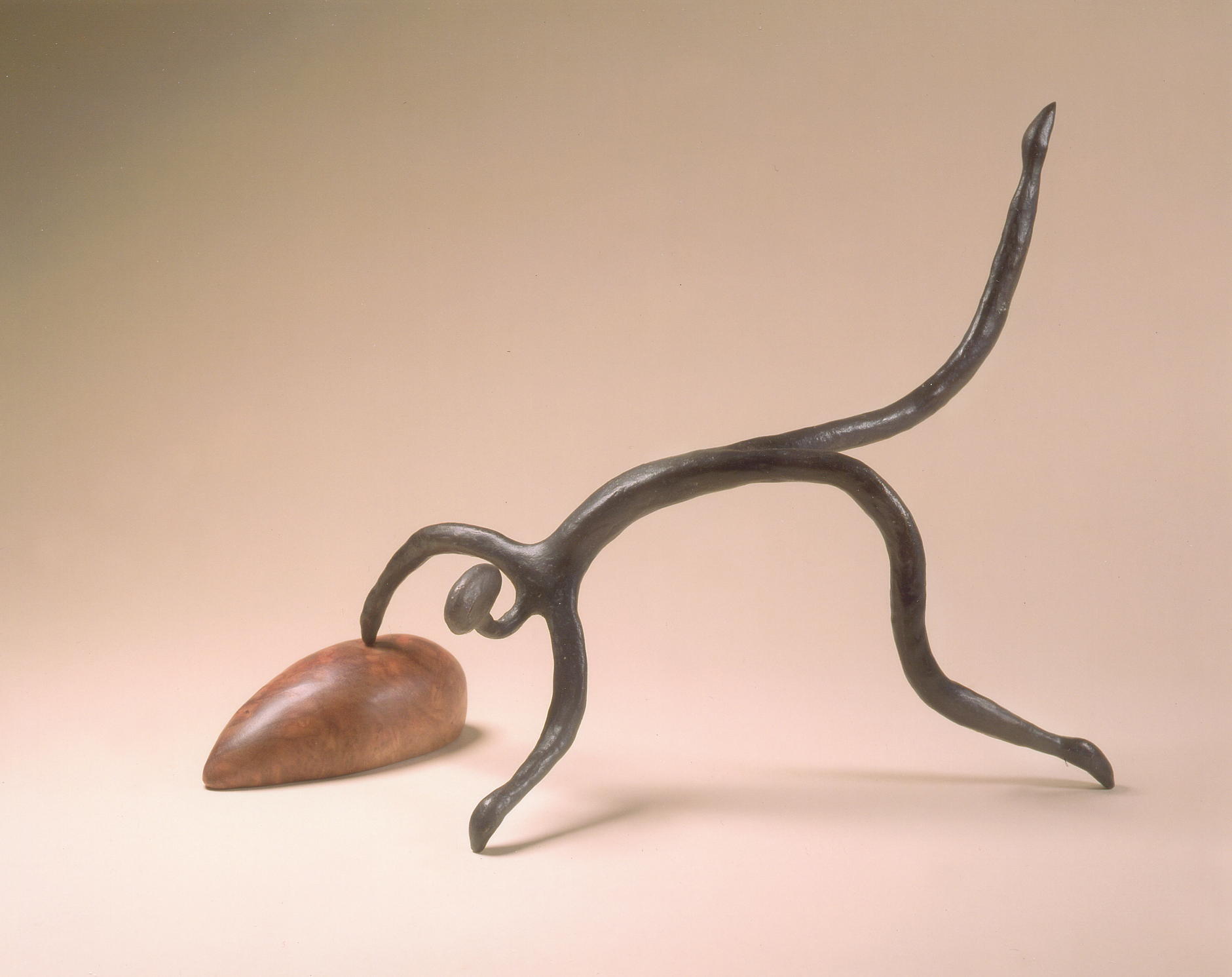 Abstract metal sculpture resembling an animal with a heart-shaped element.